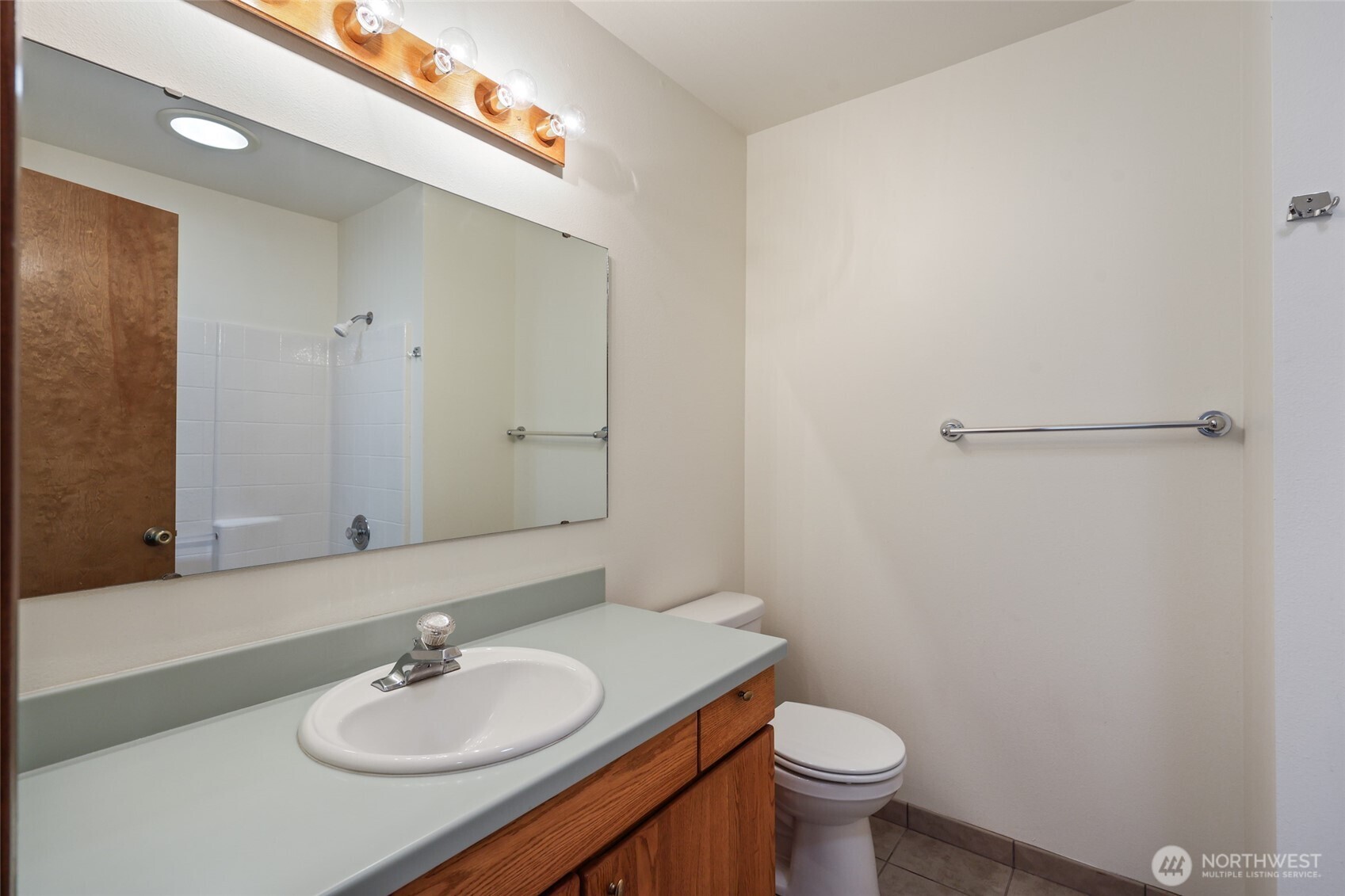 7922 Ellison Loop Northwest Olympia, WA 98502 - Photo 16 of 40 a bathroom with a sink a toilet a mirror and shower