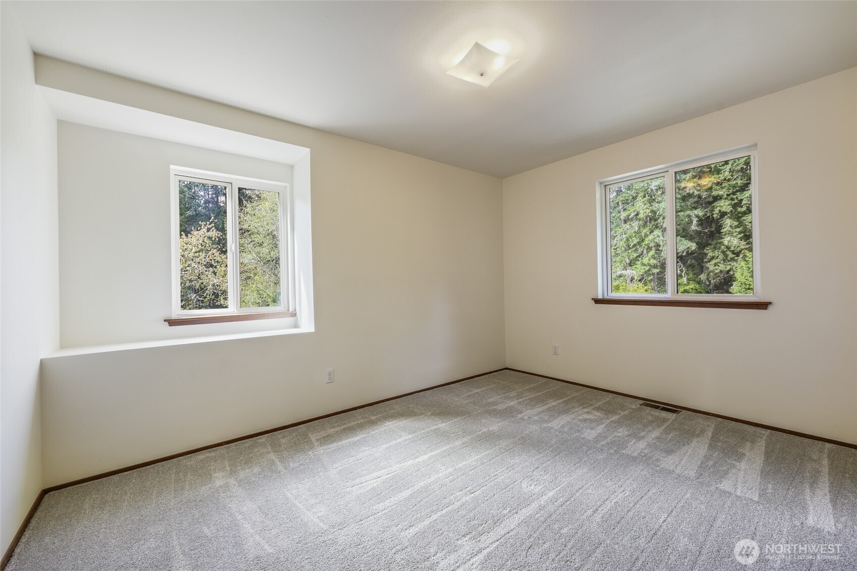 7922 Ellison Loop Northwest Olympia, WA 98502 - Photo 18 of 40 a view of an empty room with wooden floor and a window