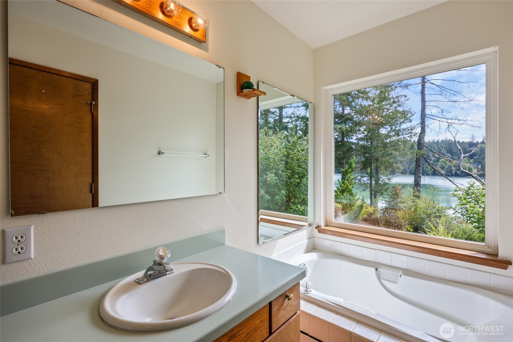 7922 Ellison Loop Northwest Olympia, WA 98502 - Photo 23 of 40 a bathroom with a sink and a window