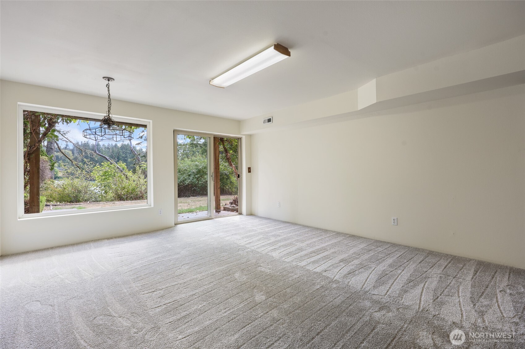 7922 Ellison Loop Northwest Olympia, WA 98502 - Photo 24 of 40 a view of an empty room with wooden floor and a window