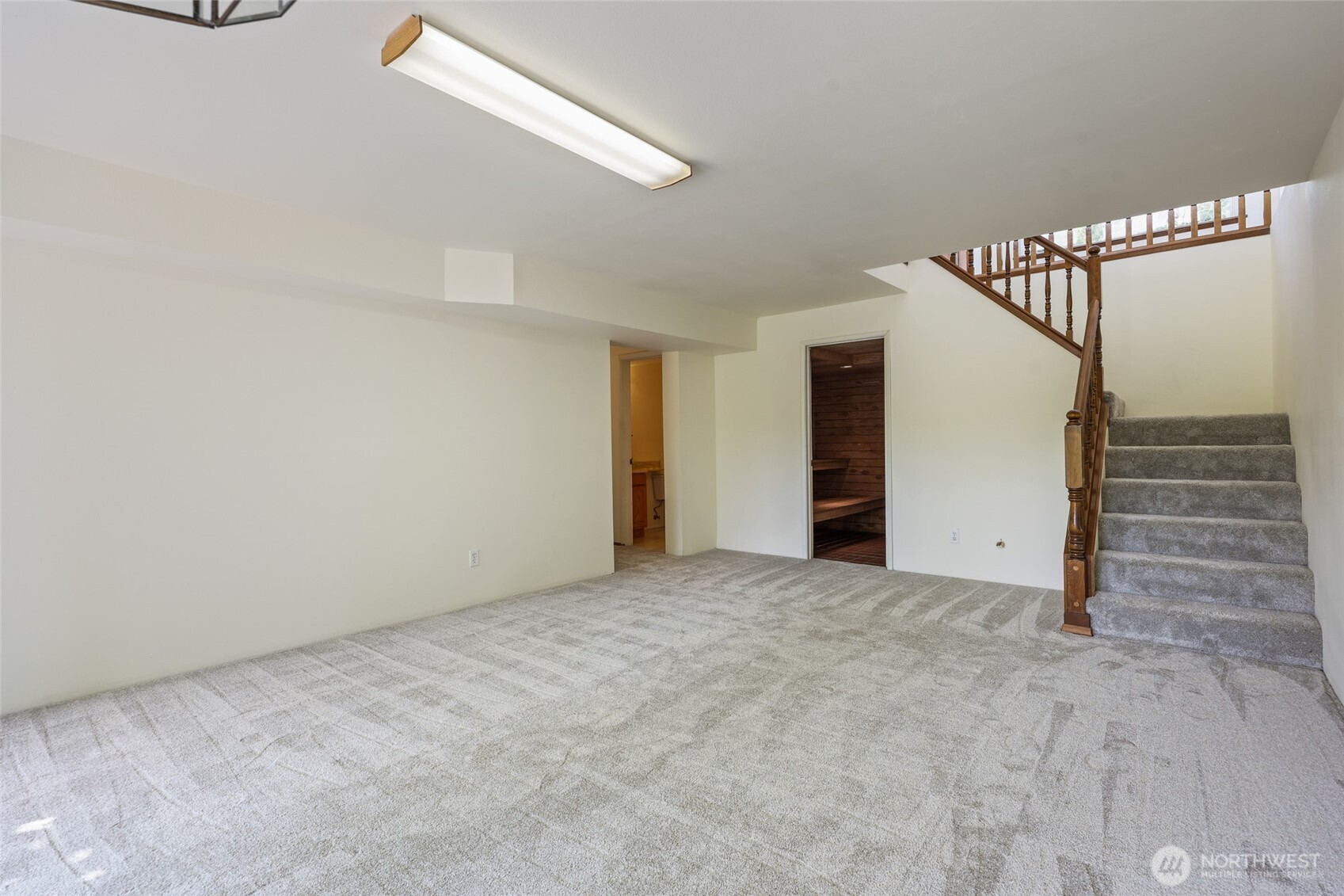 7922 Ellison Loop Northwest Olympia, WA 98502 - Photo 25 of 40 a view of an empty room with stairs and a window