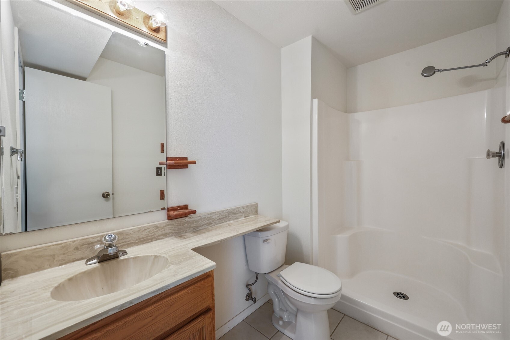 7922 Ellison Loop Northwest Olympia, WA 98502 - Photo 27 of 40 a bathroom with a sink toilet a mirror and shower