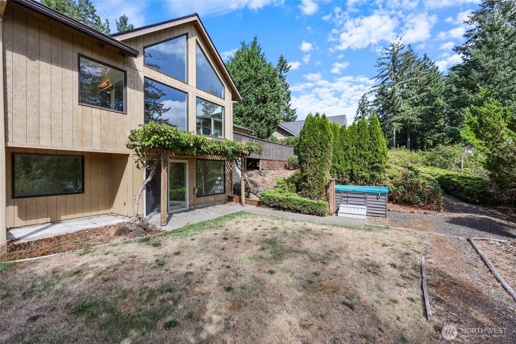 7922 Ellison Loop Northwest Olympia, WA 98502 - Photo 33 of 40 a view of a house with a small yard and a large tree