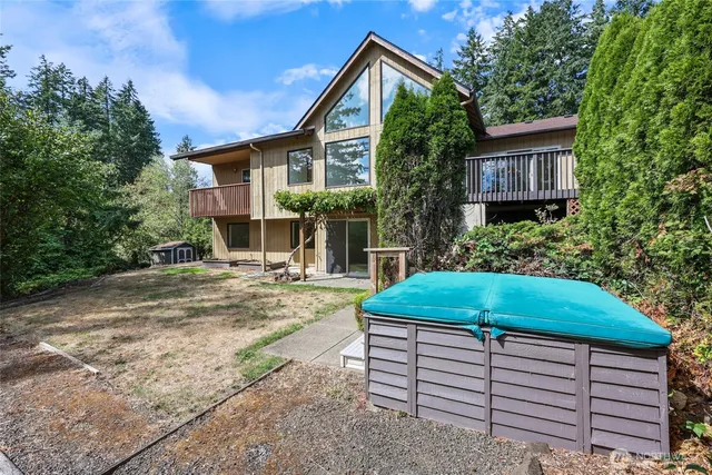 a backyard of a house with lots of green space and lake view