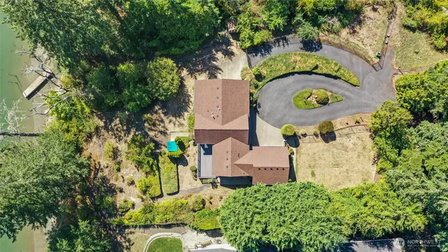 an aerial view of a house with a yard swimming pool and outdoor seating