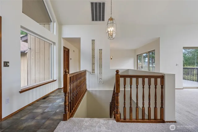 a view of wooden floor and windows in a room