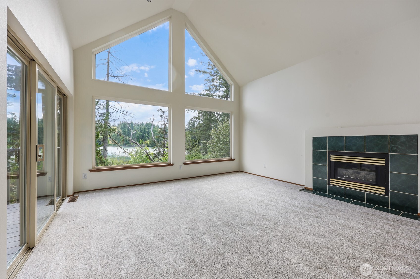 7922 Ellison Loop Northwest Olympia, WA 98502 - Photo 7 of 40 a view of an empty room with a fireplace and a window