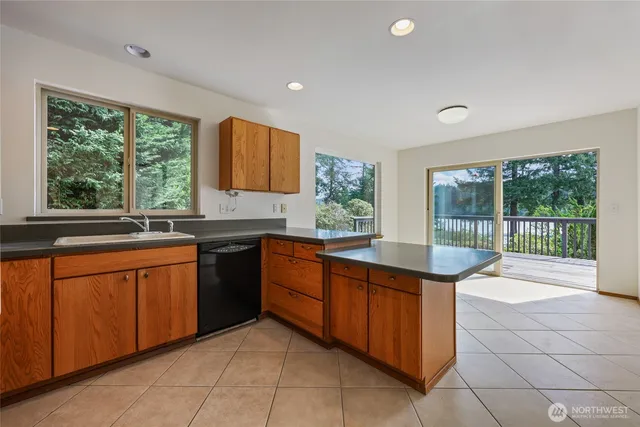 a kitchen with stainless steel appliances granite countertop a sink and a stove