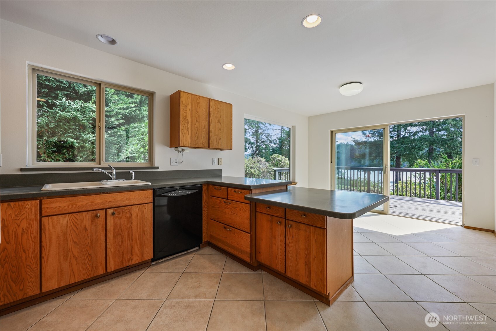 7922 Ellison Loop Northwest Olympia, WA 98502 - Photo 9 of 40 a kitchen with stainless steel appliances granite countertop a sink and a stove
