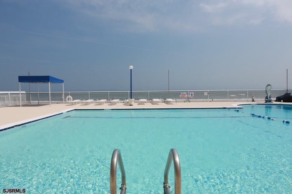 9400 Atlantic Avenue, Unit 912 Margate City, NJ 08402 - Photo 22 of 31 a kitchen with a sink and a wooden cabinets