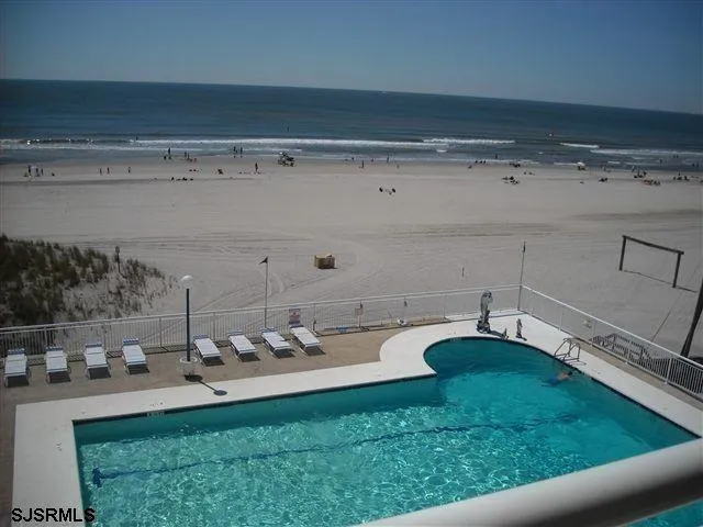 a view of a swimming pool with outdoor seating