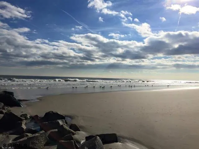 a view of swimming pool with outdoor seating and city view