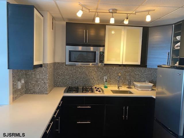 9400 Atlantic Avenue, Unit 912 Margate City, NJ 08402 - Photo 9 of 31 a kitchen with a sink a counter space cabinets and stainless steel appliances