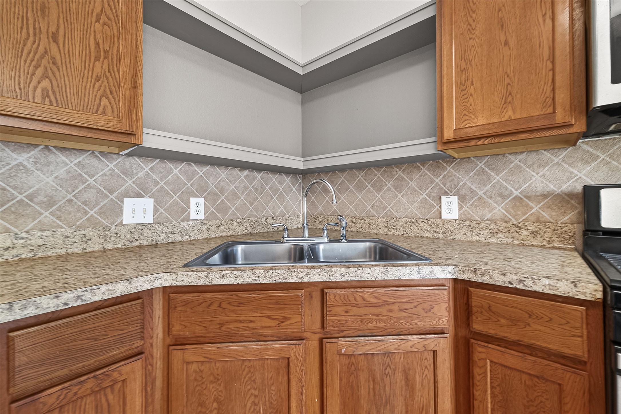 21327 Bella Flora Court Spring, TX 77379 - Photo 14 of 50 a kitchen with granite countertop stainless steel appliances sink and cabinets