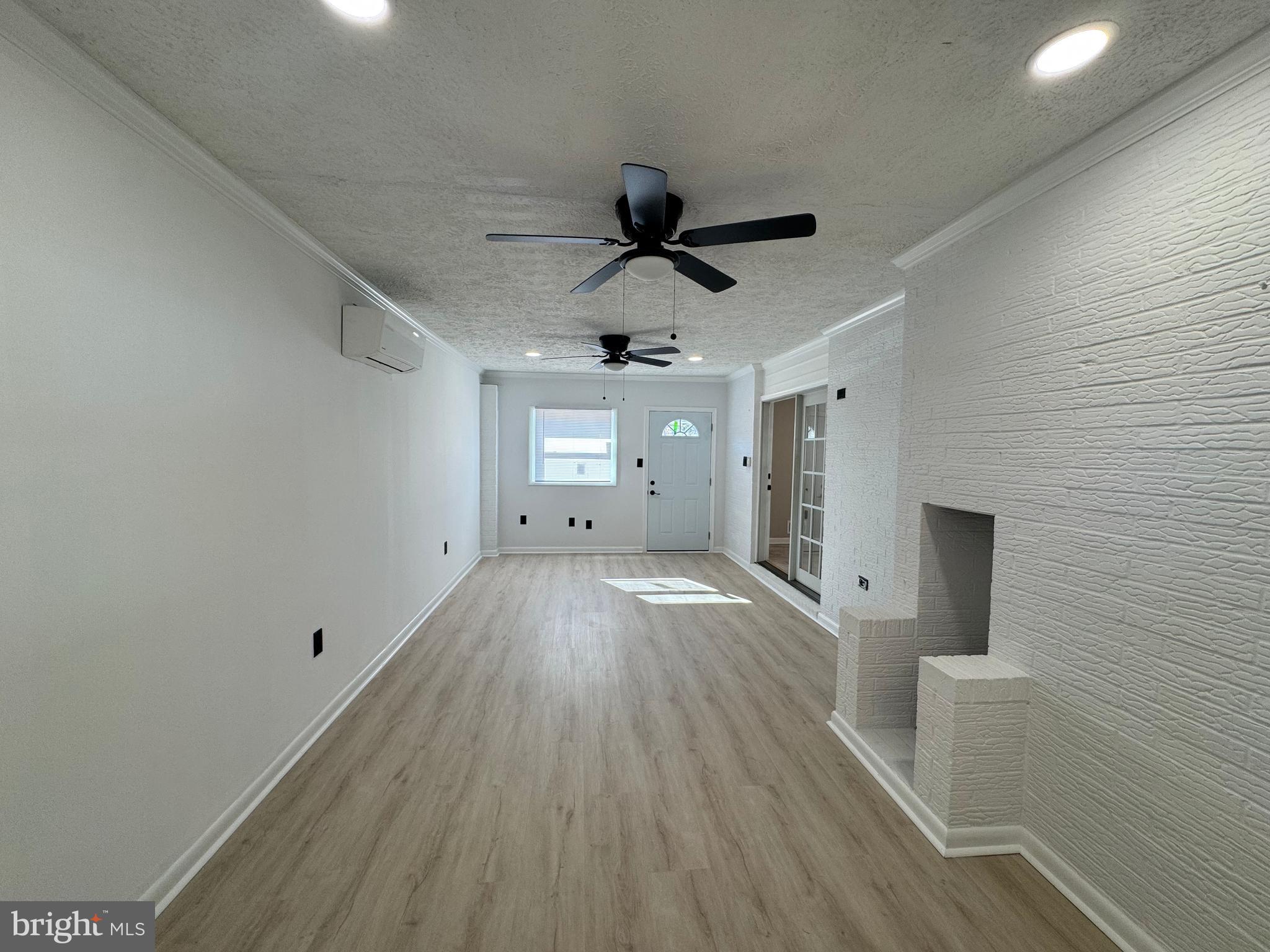 602 Eliot Road Pasadena, MD 21122 - Photo 12 of 30 a view of a livingroom with wooden floor and a ceiling fan