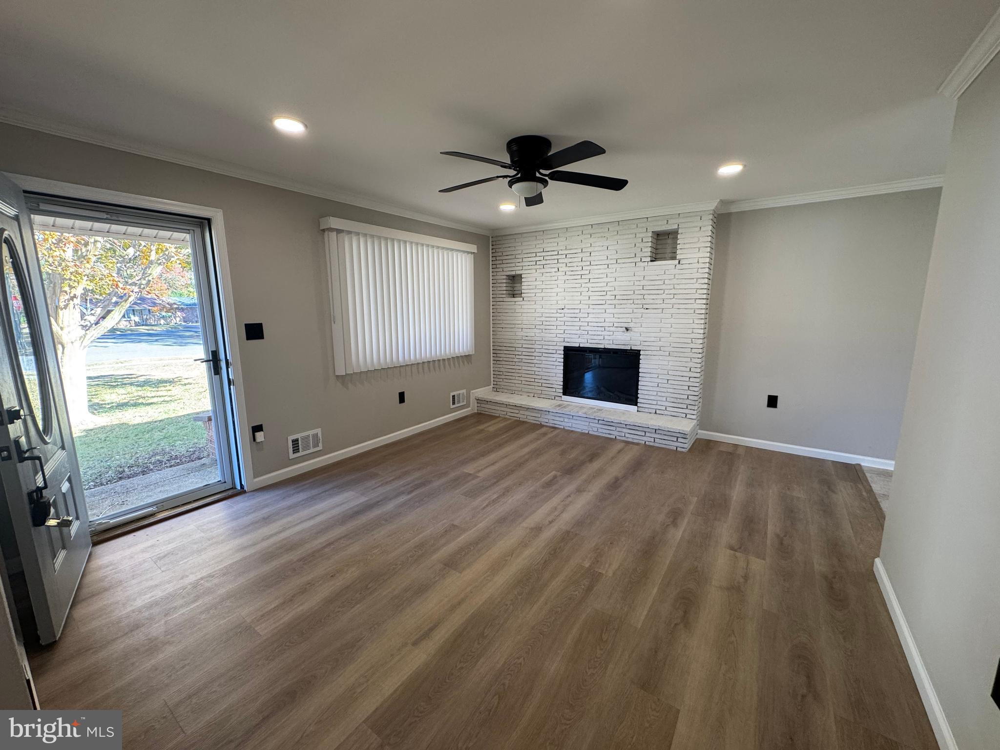 602 Eliot Road Pasadena, MD 21122 - Photo 18 of 30 wooden floor fireplace and windows in an empty room
