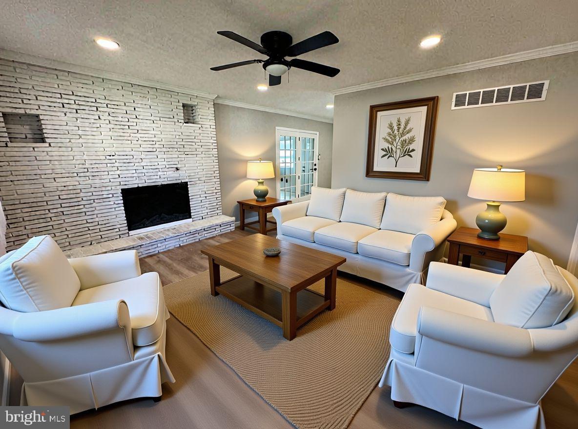 602 Eliot Road Pasadena, MD 21122 - Photo 19 of 30 a living room with furniture a flat screen tv and a fireplace