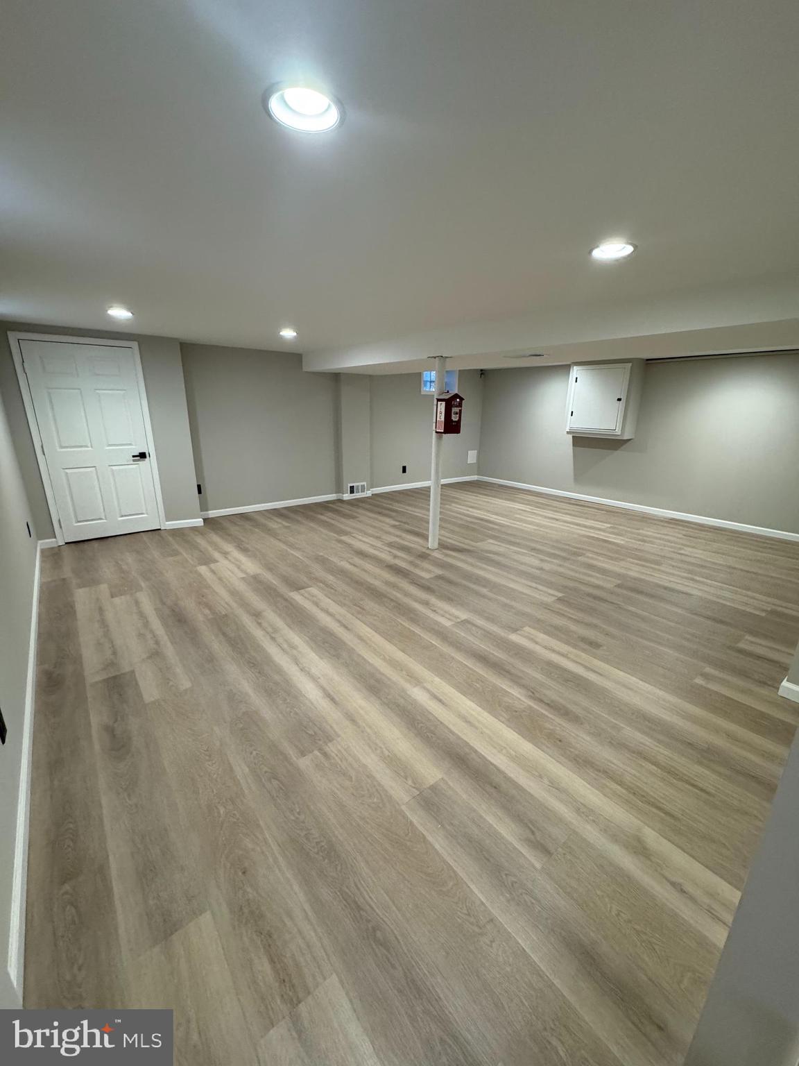 602 Eliot Road Pasadena, MD 21122 - Photo 26 of 30 an empty room with wooden floor and windows