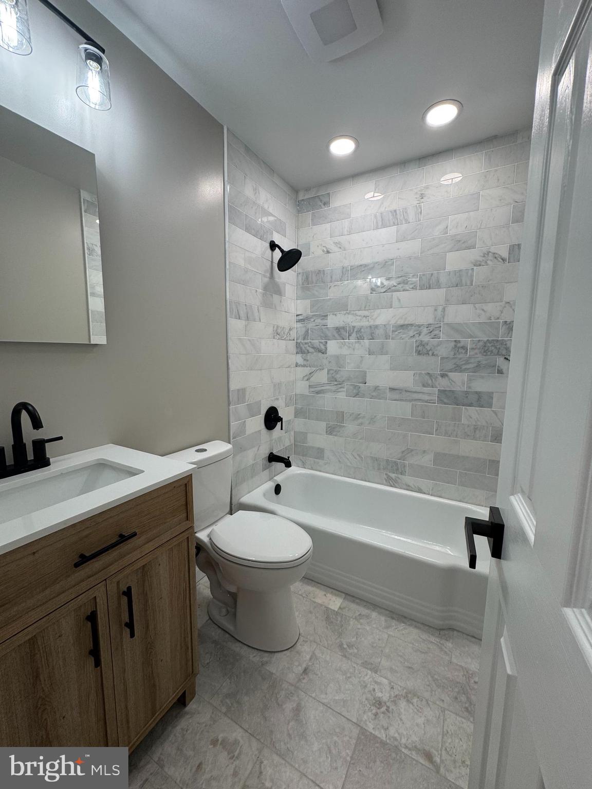 602 Eliot Road Pasadena, MD 21122 - Photo 28 of 30 a bathroom with a double vanity sink toilet and bathtub
