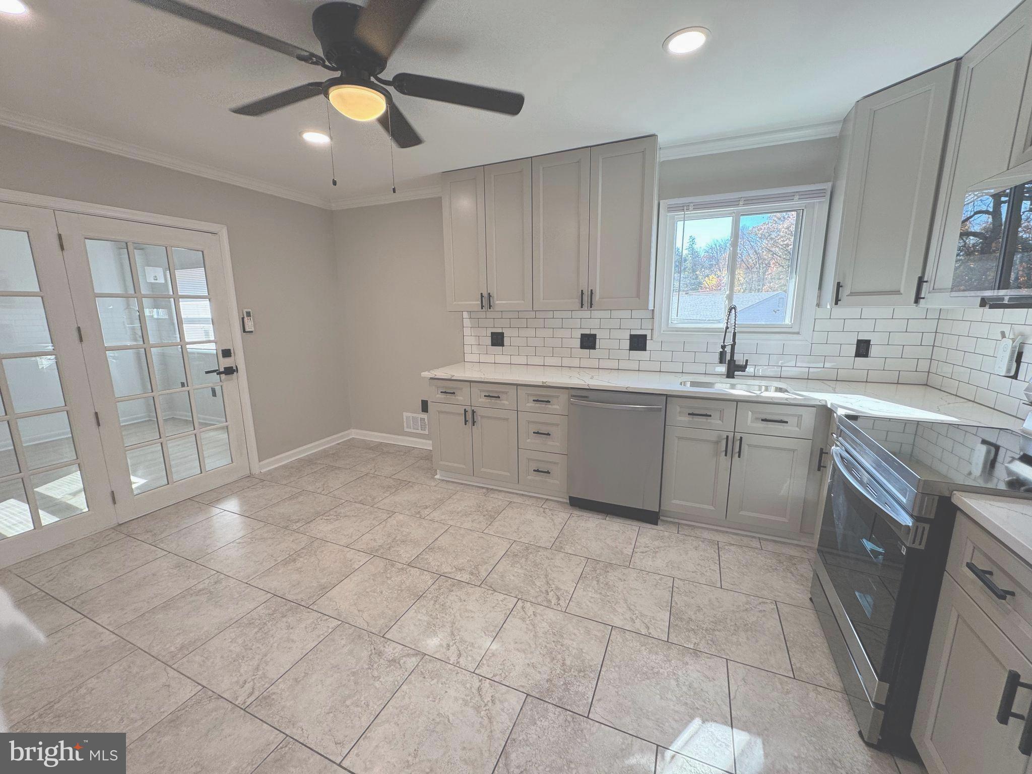 602 Eliot Road Pasadena, MD 21122 - Photo 3 of 30 a view of a kitchen with a sink and cabinets