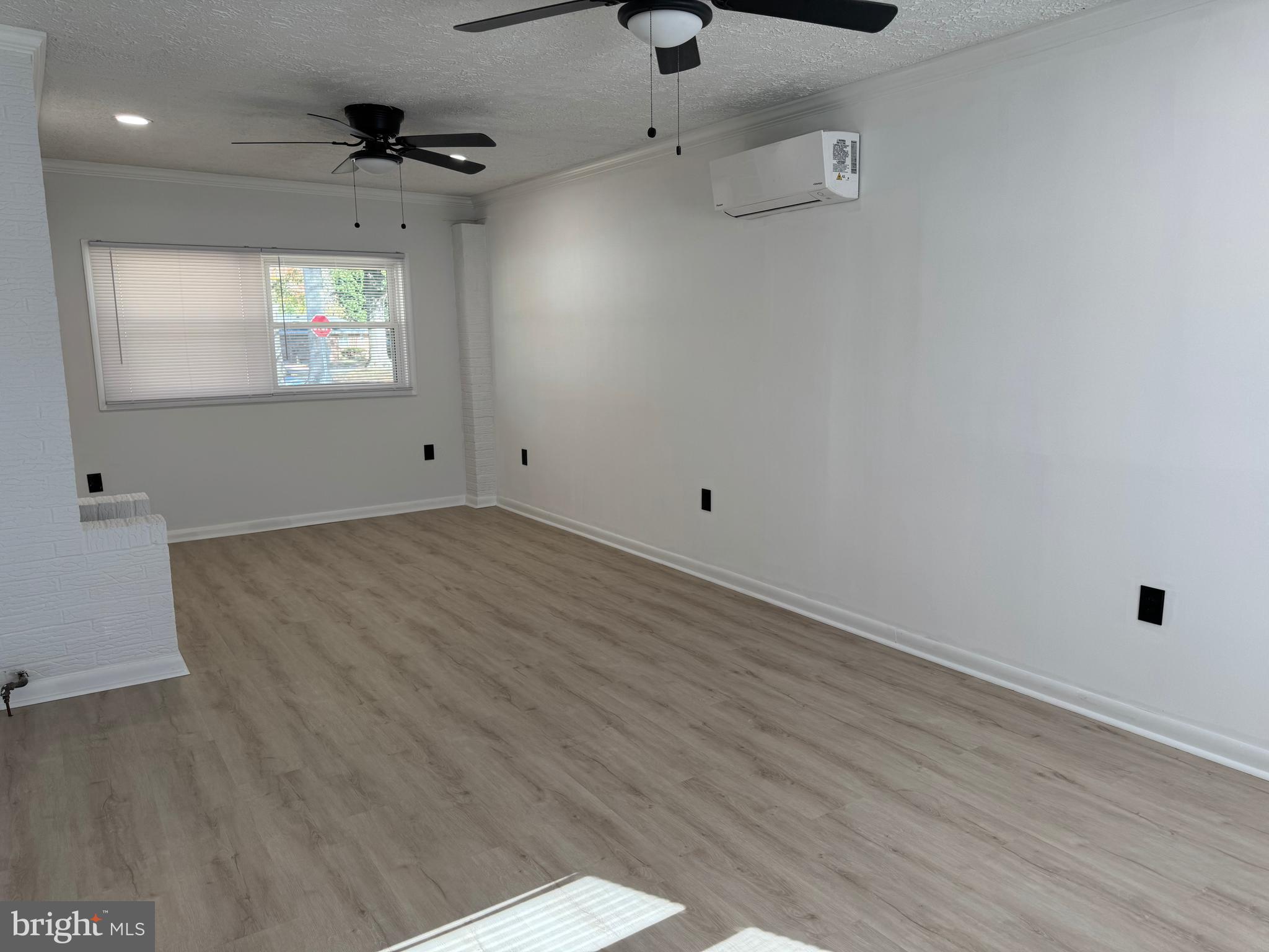 602 Eliot Road Pasadena, MD 21122 - Photo 10 of 30 an empty room with wooden floor and windows