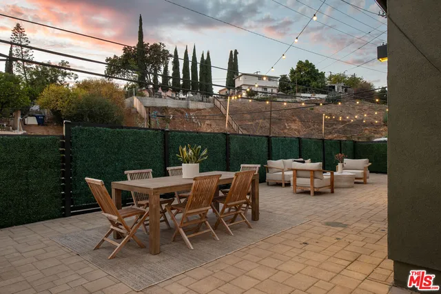 a view of a patio with a table and chairs