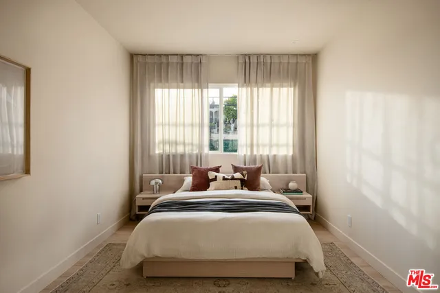 a bedroom with a bed and window