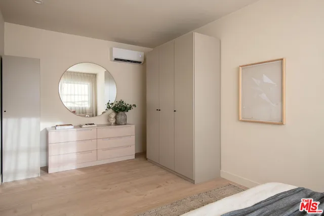 a view of a hallway with dresser and mirror