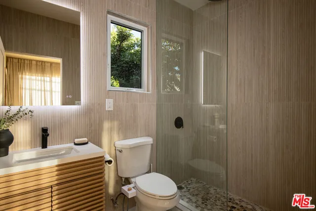 a white toilet sitting next to a bathroom sink