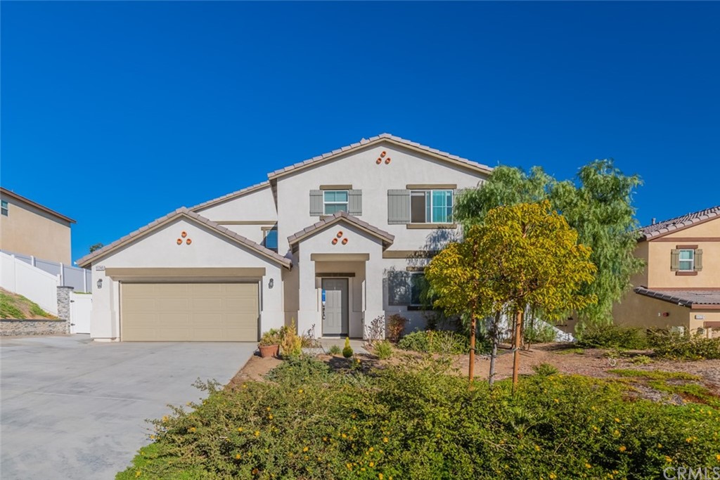 11745 Connell Road Riverside, CA 92505 - Photo 1 of 1 a front view of a house with a yard and garage