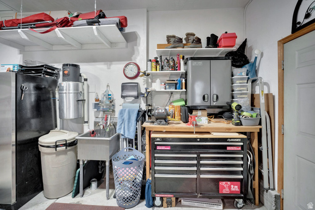 2139 Village Point Way Sandy, UT 84093 - Photo 29 of 35 Utility sink, built in workbench (toolbox excluded), wall-mounted cabinet and shelving, garage also has attic space storage with a pull down ladder for easy access.
