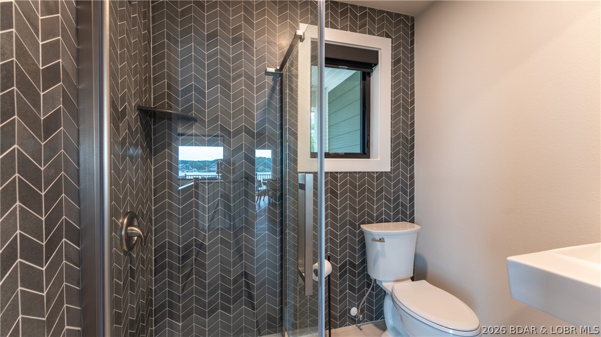 5590 Alona Point Osage Beach, MO 65065 - Photo 20 of 46 Guest Bathroom with custom tilework on main level