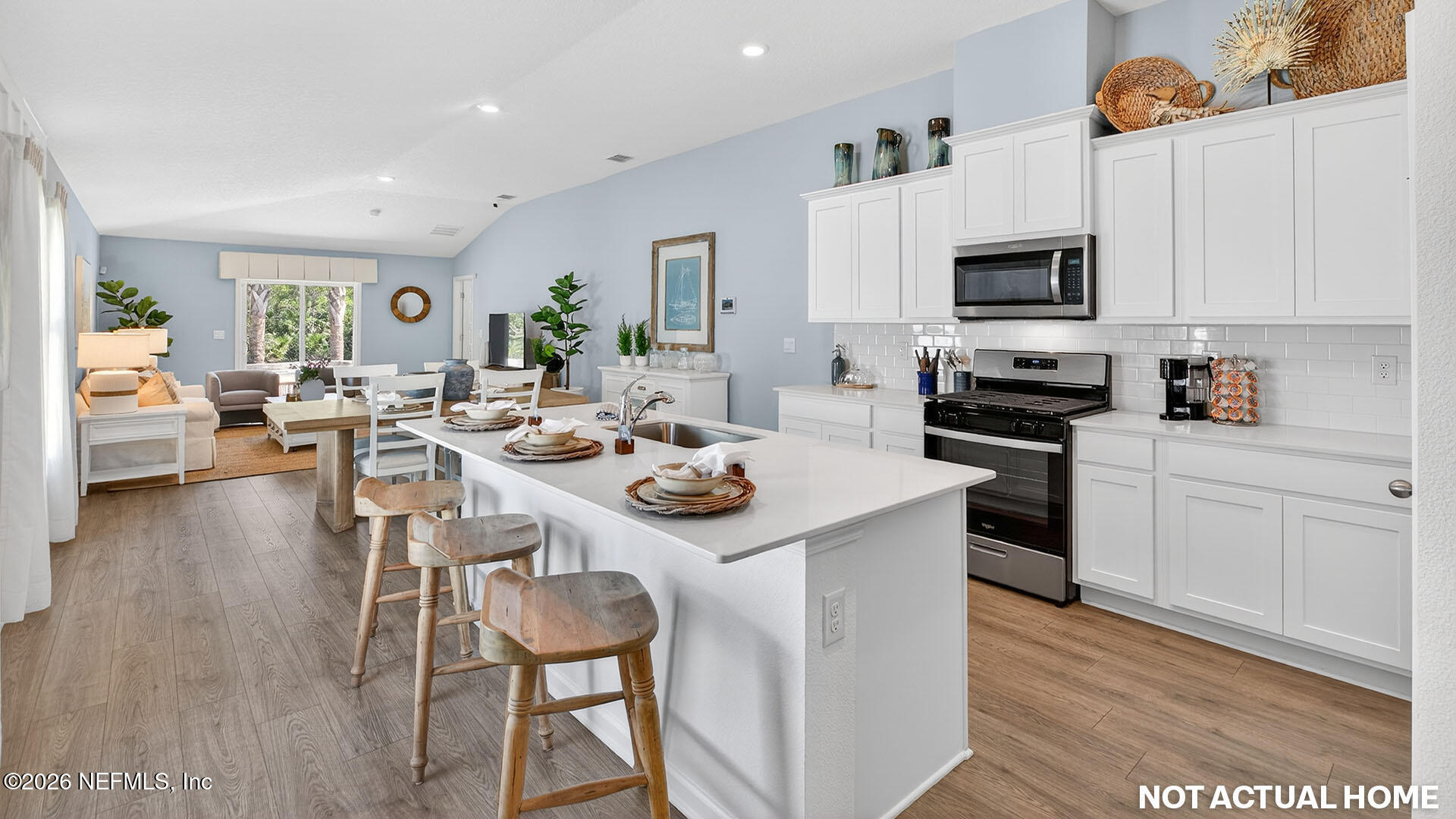 36 Divot Place Bunnell, FL 32110 - Photo 6 of 58 a kitchen with stainless steel appliances a white table and chairs in it