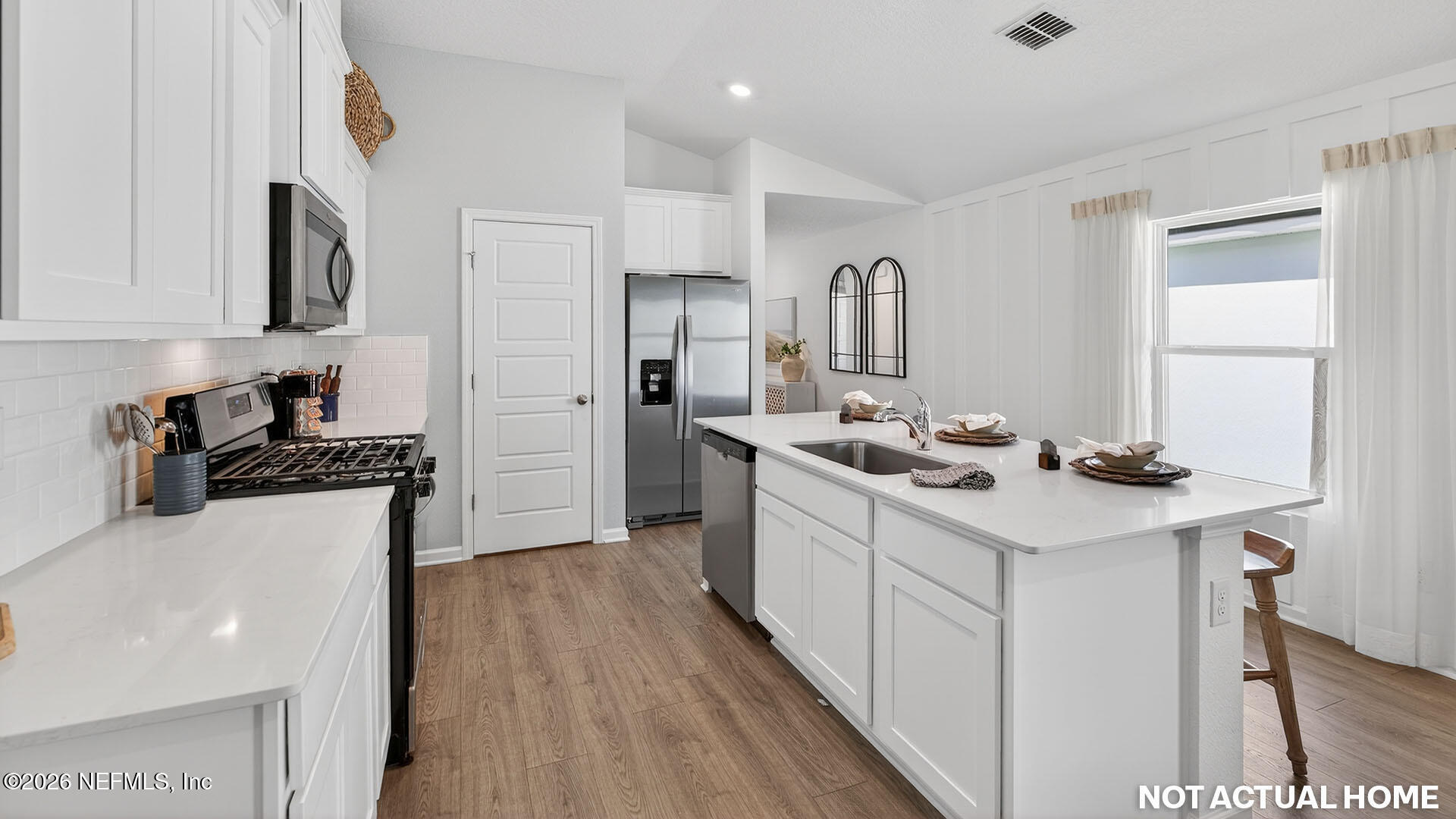 36 Divot Place Bunnell, FL 32110 - Photo 8 of 58 a kitchen with stainless steel appliances a sink stove and cabinets