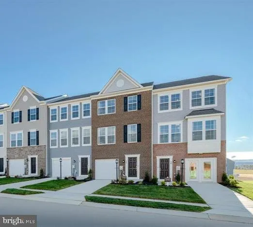 a front view of a building with a yard