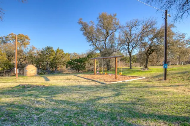 a view of a yard with basketball court