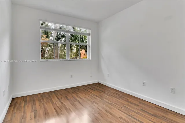 a bedroom with a bed and a potted plant