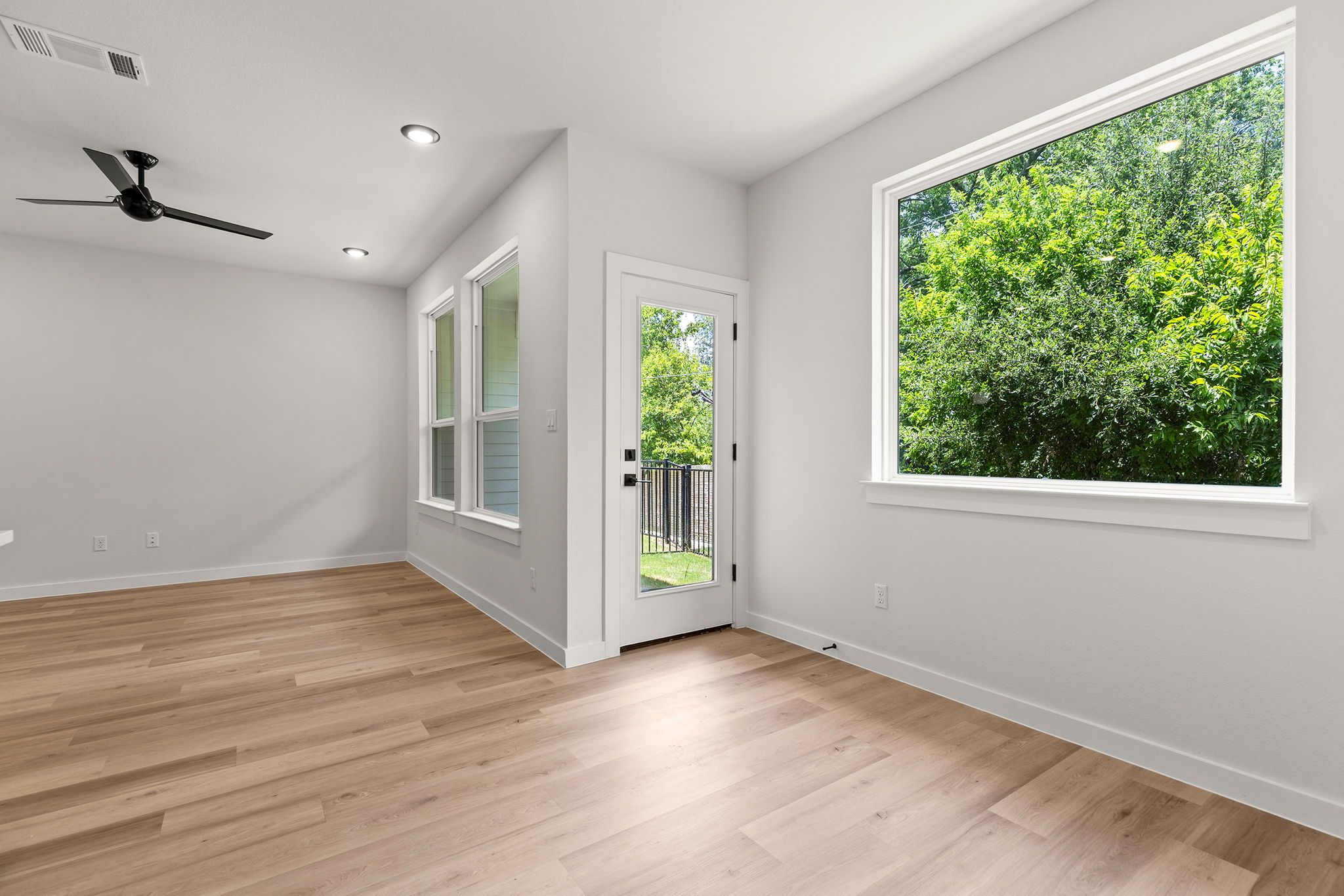 2600 Gattis School Road, Unit 1002 Round Rock, TX 78664 - Photo 11 of 40 A well-lit living area boasts light-toned wood flooring and direct outdoor access.