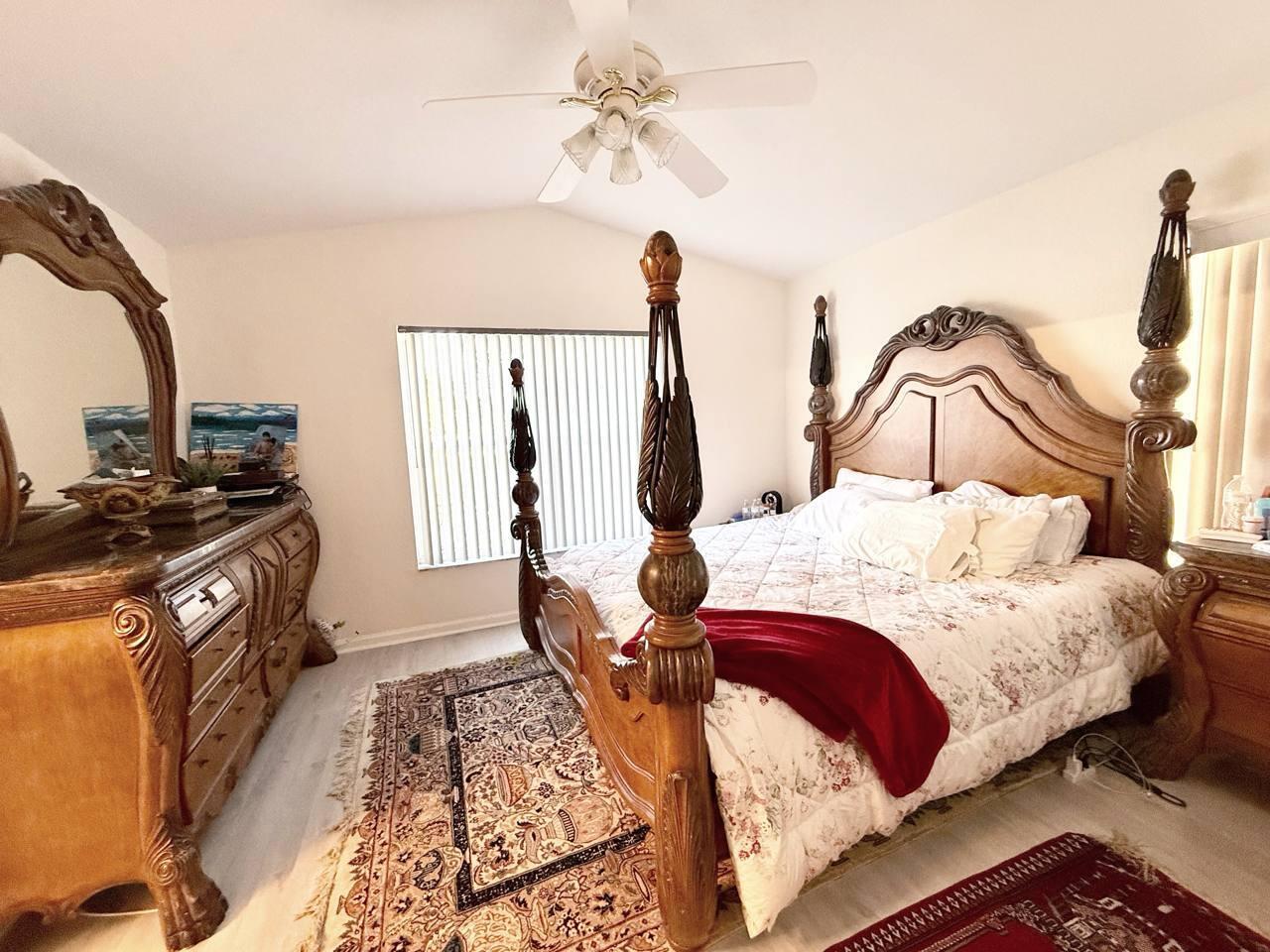 1067 Big Torch Street Riviera Beach, FL 33407 - Photo 11 of 23 a bedroom with a bed and wooden floor