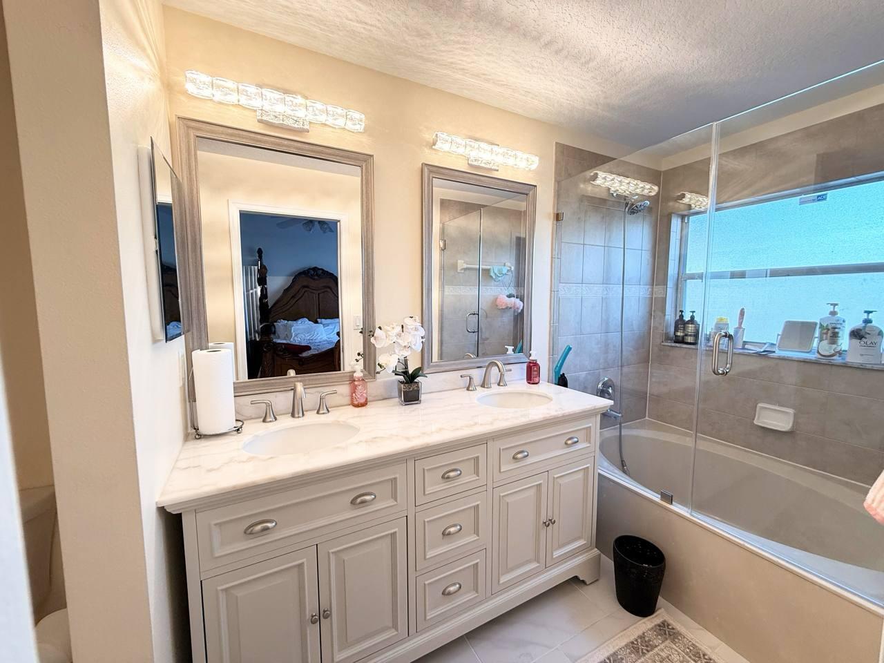 1067 Big Torch Street Riviera Beach, FL 33407 - Photo 14 of 23 a bathroom with a granite countertop sink mirror and bathtub