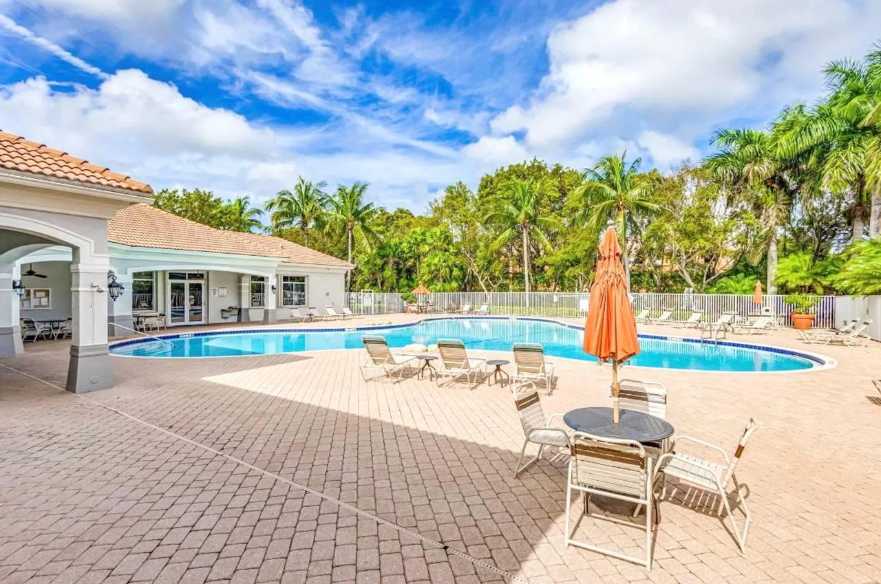 1067 Big Torch Street Riviera Beach, FL 33407 - Photo 19 of 23 a balcony with table and chairs