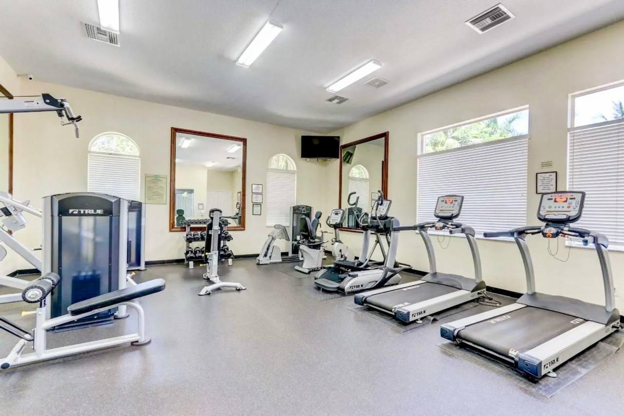 1067 Big Torch Street Riviera Beach, FL 33407 - Photo 23 of 23 a room with gym equipment and large mirror