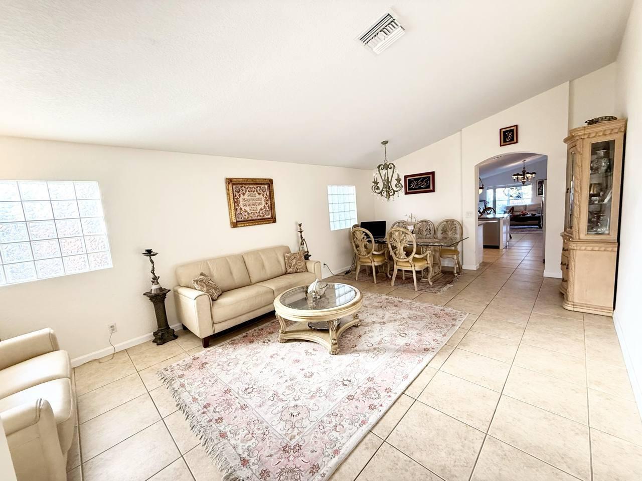 1067 Big Torch Street Riviera Beach, FL 33407 - Photo 5 of 23 a living room with furniture a dining table and a window