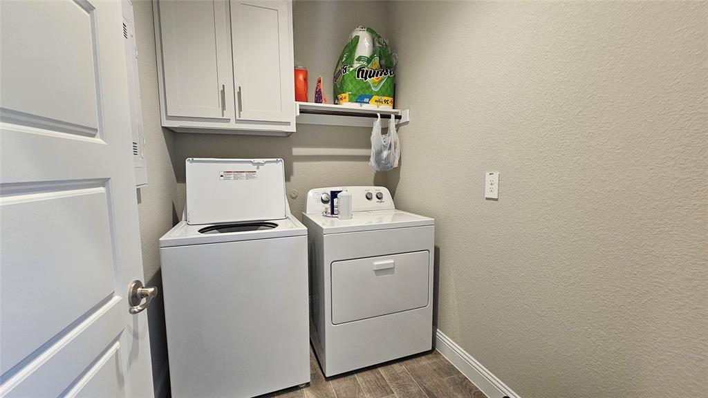 1405 Razorbill Road Denton, TX 76205 - Photo 13 of 40 a utility room with dryer and washer