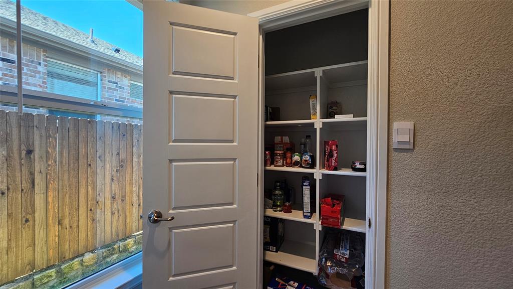 1405 Razorbill Road Denton, TX 76205 - Photo 14 of 40 a view of walk in closet with clothes and shoes