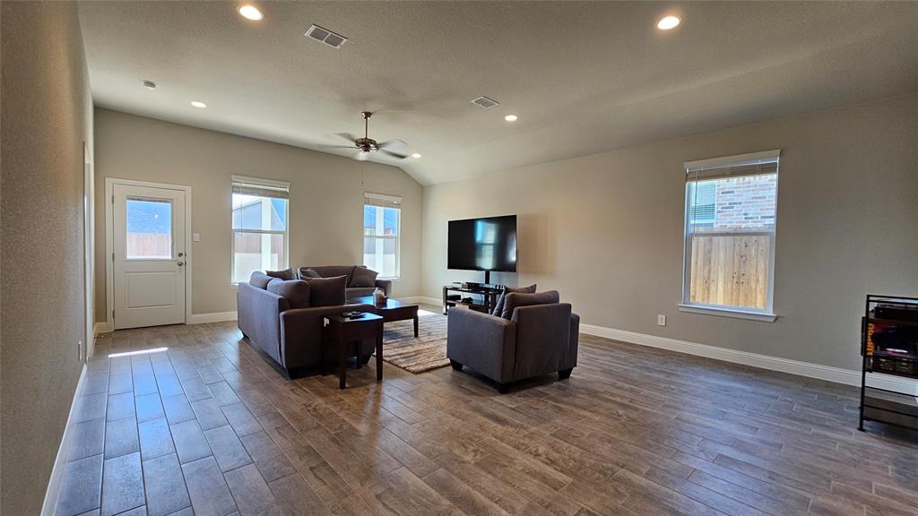 1405 Razorbill Road Denton, TX 76205 - Photo 15 of 40 a living room with furniture and a flat screen tv