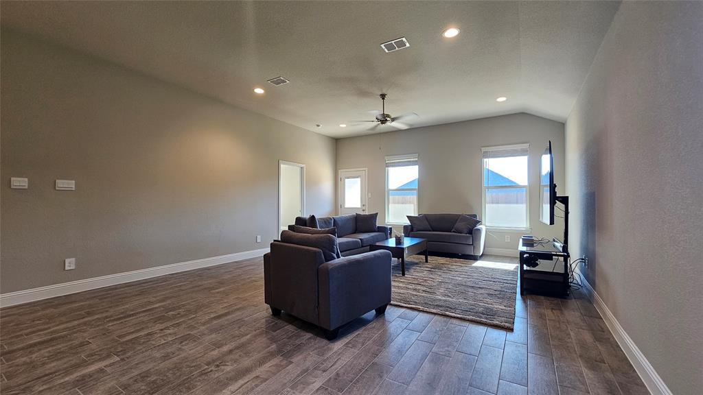 1405 Razorbill Road Denton, TX 76205 - Photo 17 of 40 a living room with furniture and a wooden floor