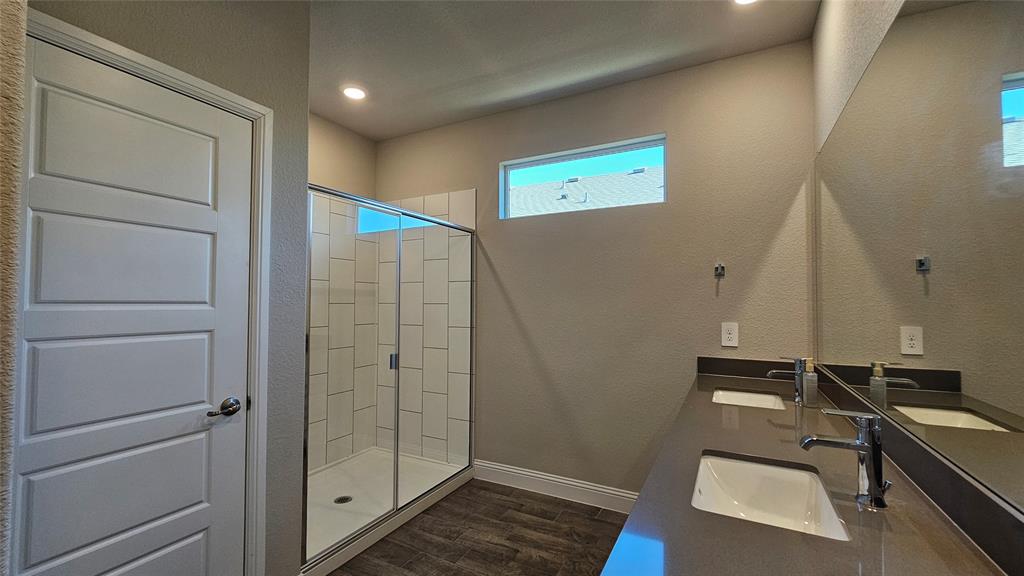 1405 Razorbill Road Denton, TX 76205 - Photo 21 of 40 a bathroom with a sink and a mirror