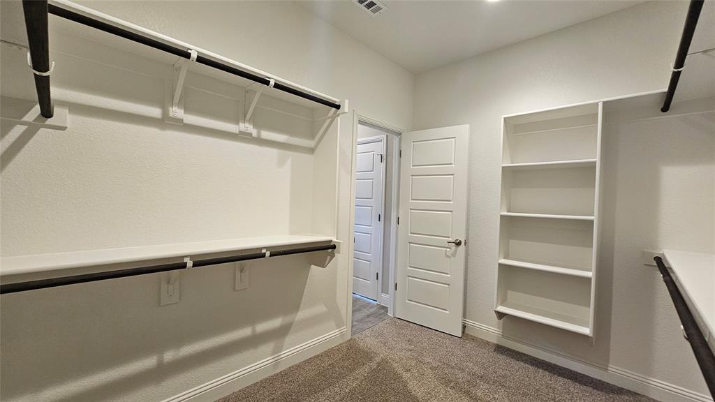 1405 Razorbill Road Denton, TX 76205 - Photo 24 of 40 a view of walk in closet with empty racks