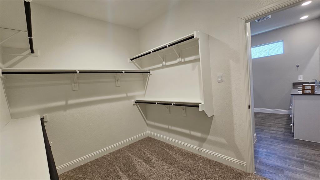 1405 Razorbill Road Denton, TX 76205 - Photo 25 of 40 a view of walk in closet with empty racks